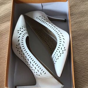 White eyelet pointy toe heels.